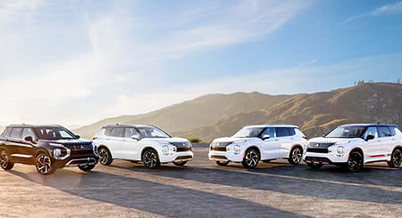 Four mitsubishi standing in the desert, sunset in the background