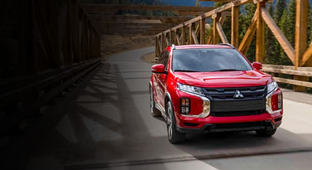 A red mitsubishi standing on a bridge