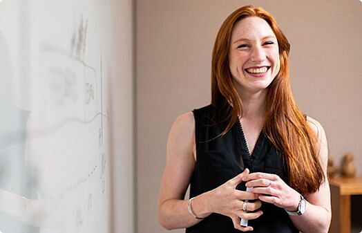 A woman teacher standing holding something in her hands