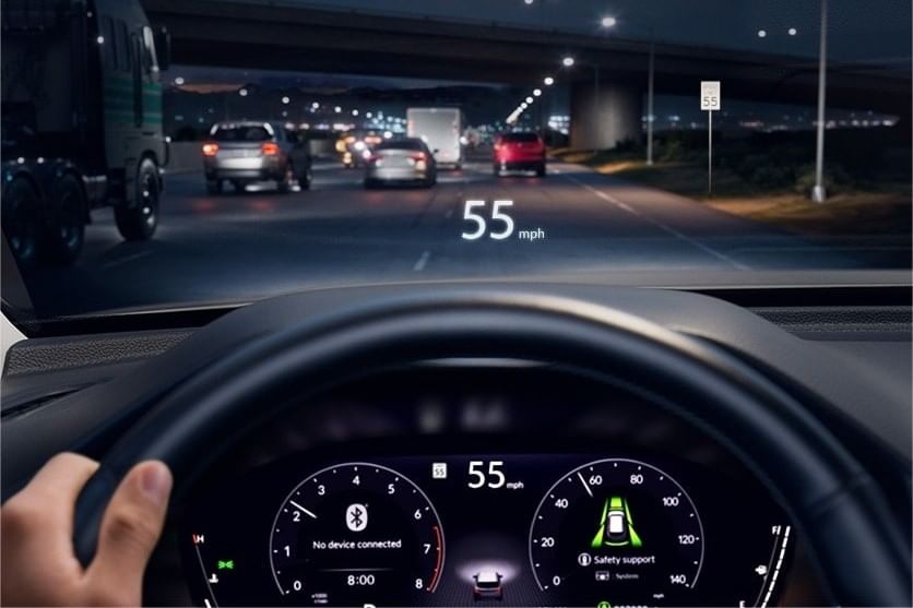 Dashboard view of a 2025 Honda Pilot at night showing speedometer reading 55 mph and heads-up display with speed information and safety features.
