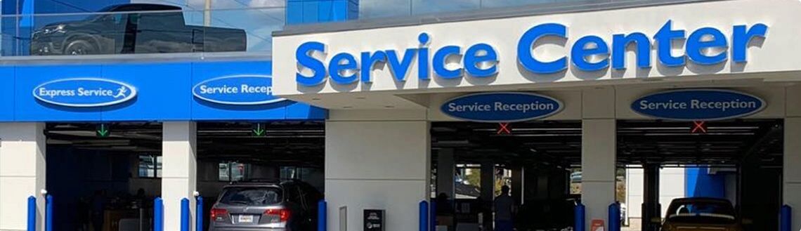 Honda Service Center during the day with vehicles in service bays