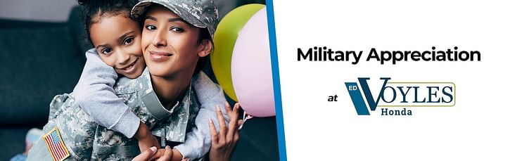 A girl smiling while holding her military mother