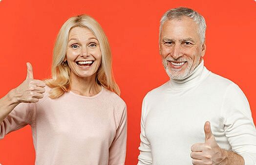 Man and a woman showing thumbs up