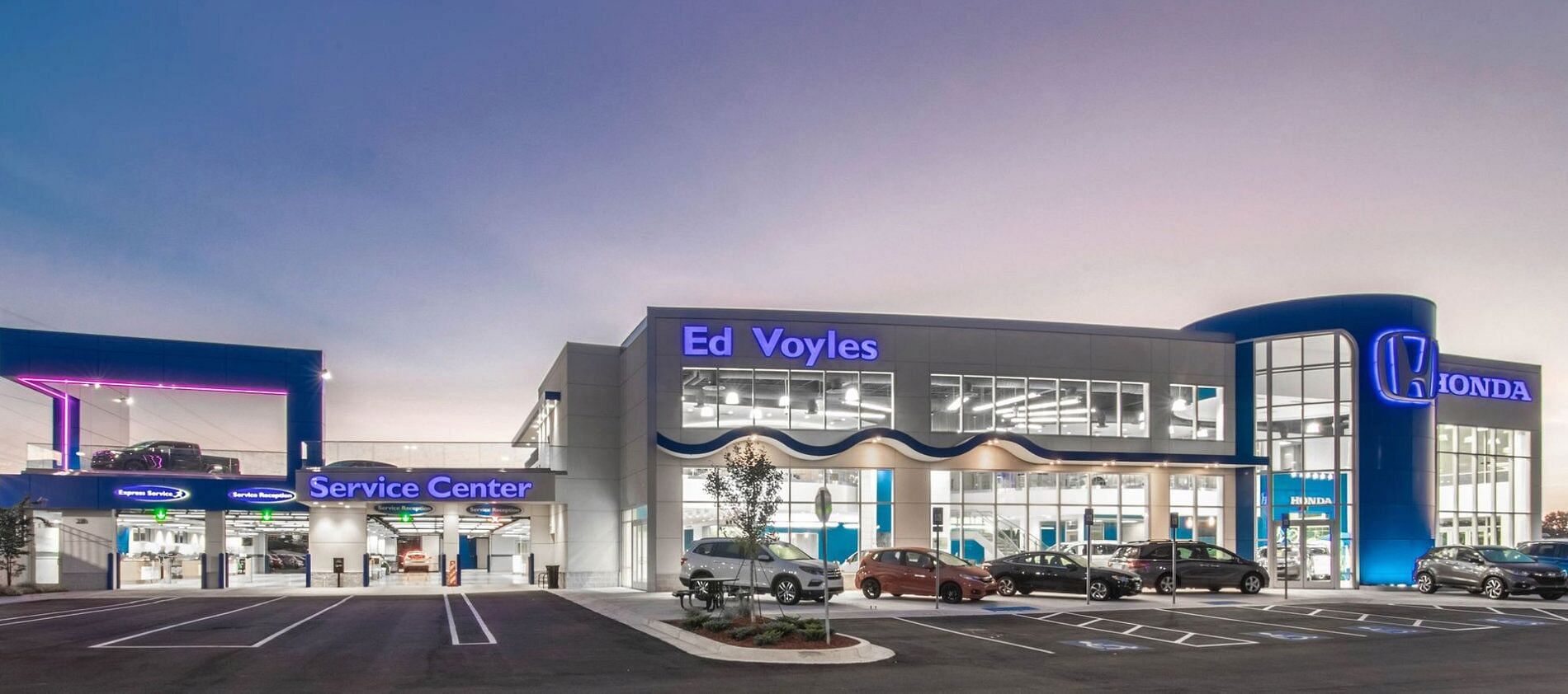 Ed Voyles Honda dealership with lights on during dusk