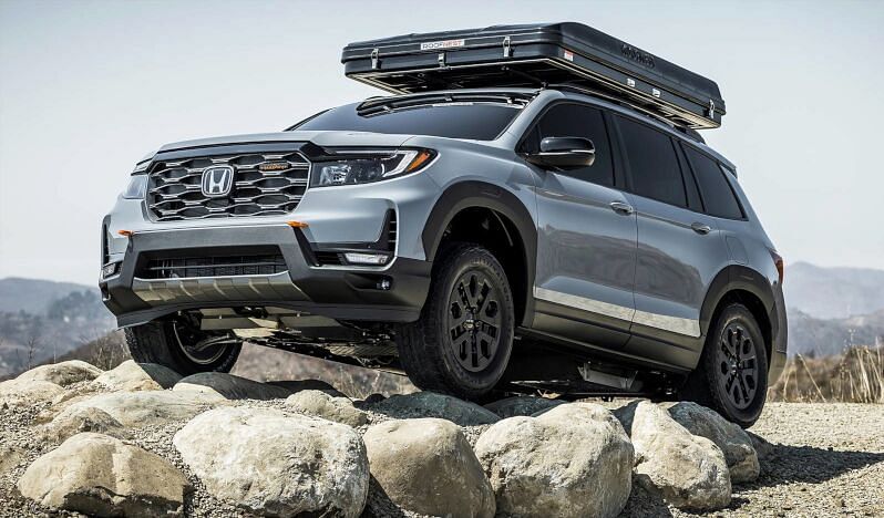 Gray Honda Passport on the rocks