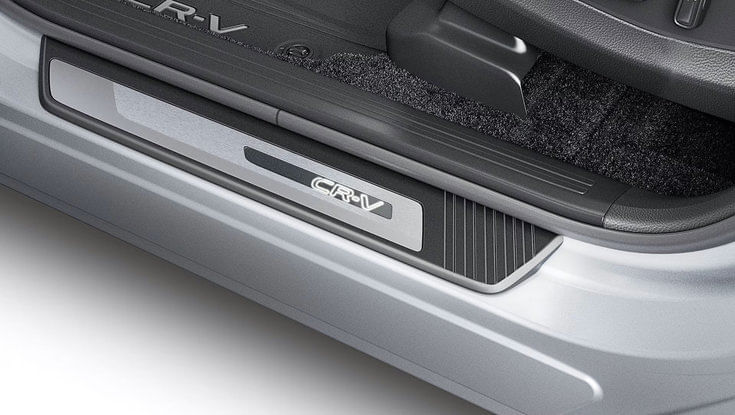 A close-up of the CR-V logo on the car's door sill plate.