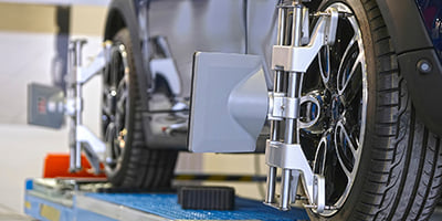Mechanic working on wheel alignment 