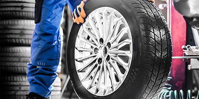 Mechanic holding tire