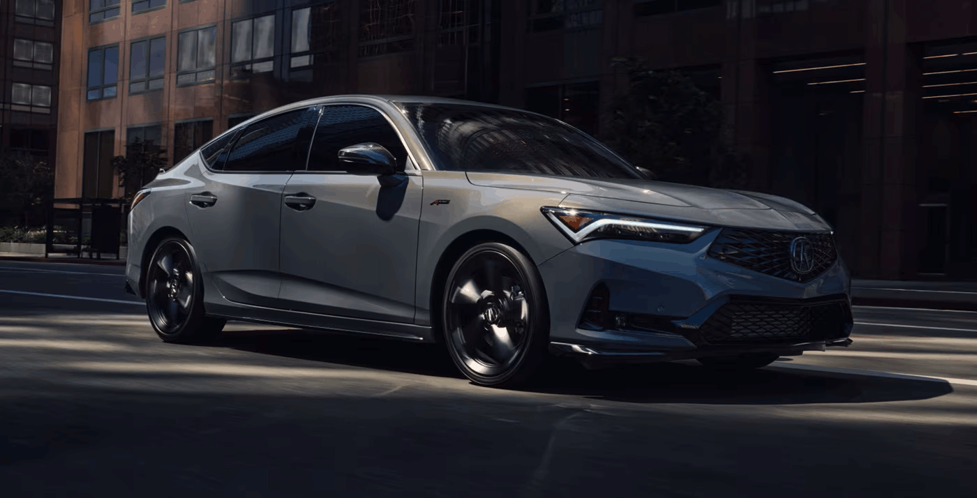 The 2026 Acura Integra 3/4 front view driving in Urban Gray Pearl.