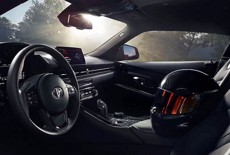 2022 GR Supra's interior depicted with a racing helmet on the console