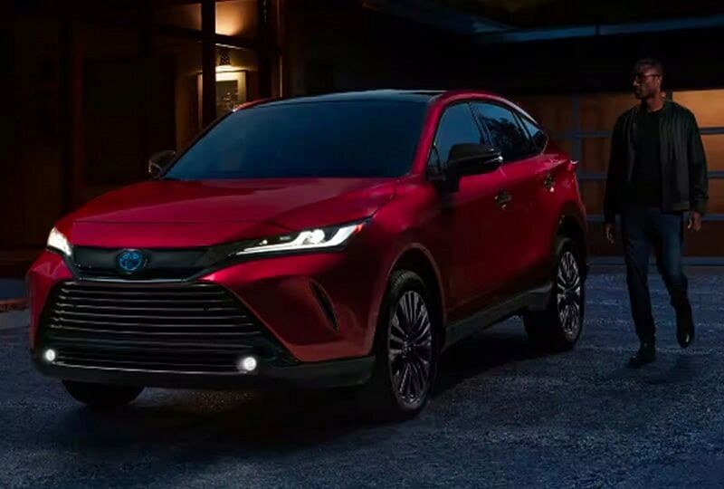 2023 Toyota Venza parked at night with driver walking towards it