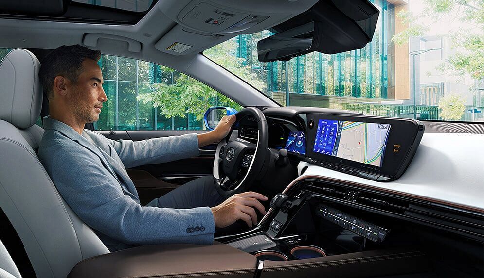 A man behind the wheel inside Toyota vehicle with bright interior