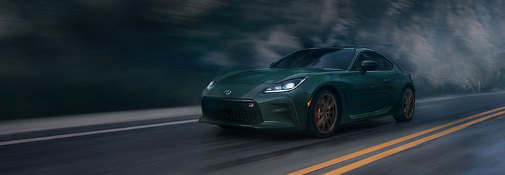 A grey Toyota GR86 driving on the road
