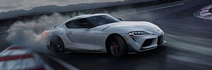 A white GR Supra drifting on a track