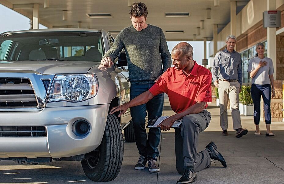 Man checking tire tread