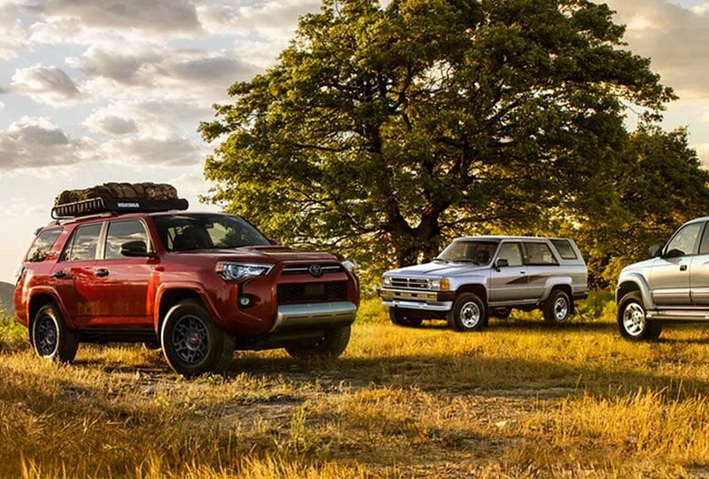 2022 4Runner parked in an outdoor setting along side older style off road vehicles