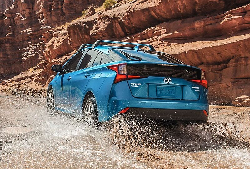 Prius is driving through water on an off road trail