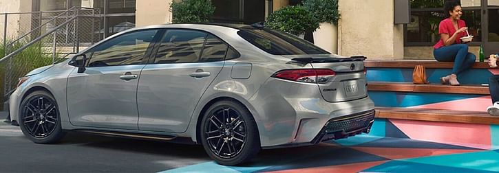 2022 Corolla XSE Apex Edition parked in front of a modern building