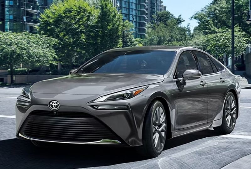  A Toyota navigating a city street, highlighting its modern style against an urban backdrop.