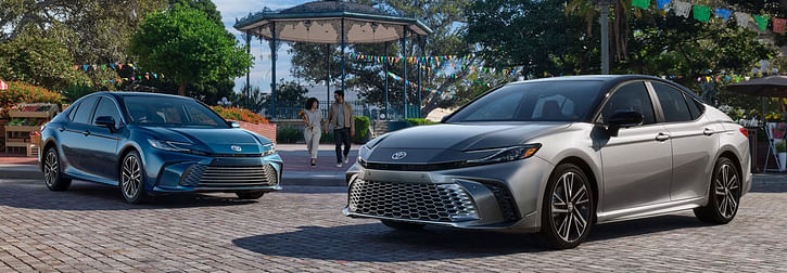 Two 2025 Toyota Camry cars parked side by side in a parking lot.