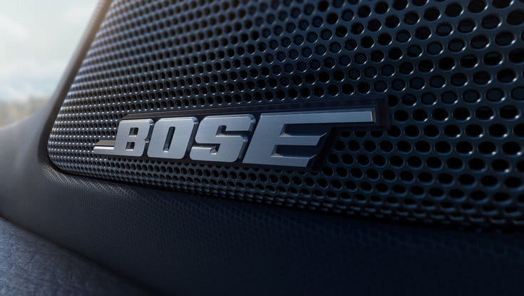 A close-up of the Bose logo on a car's speaker grille.