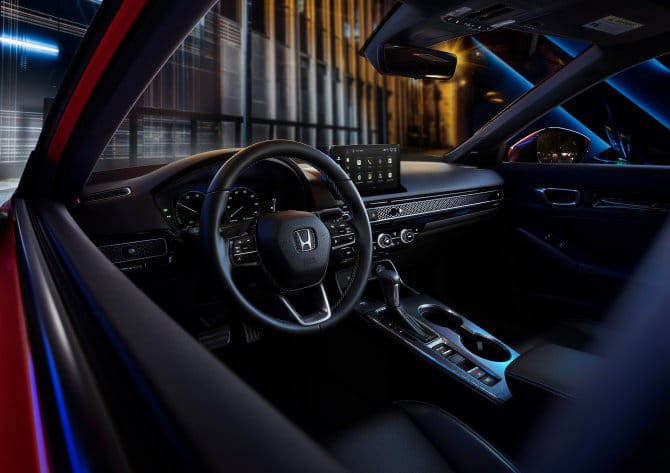 View of the 2025 Honda Civic Hybrid's steering wheel featuring paddle shifters and deceleration control selectors.