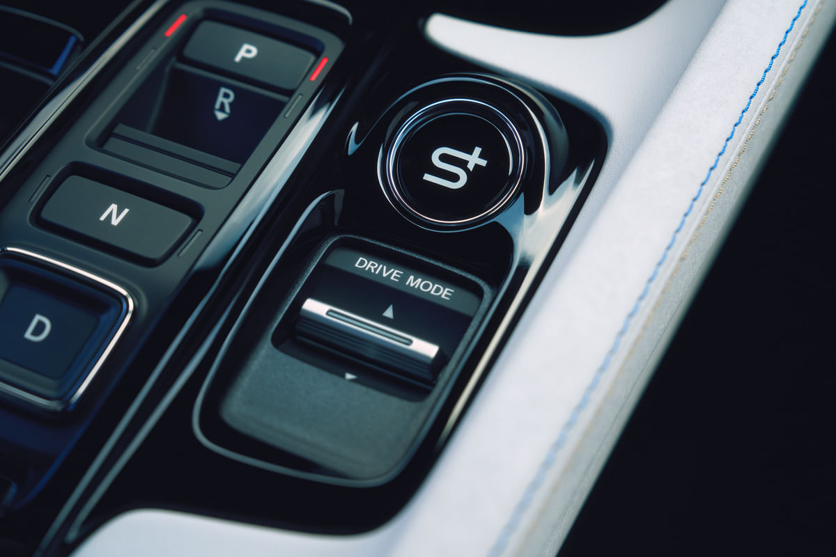 A close-up of the 2026 Honda Prelude's center console, focusing on the push-button gear selector and the prominent round button for the new S+ drive mode.