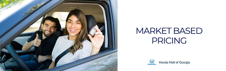 Woman driving car and man on the passenger seat on the left and on the right the inscription: Market Based Pricing Honda Honda Mall of Georgia.