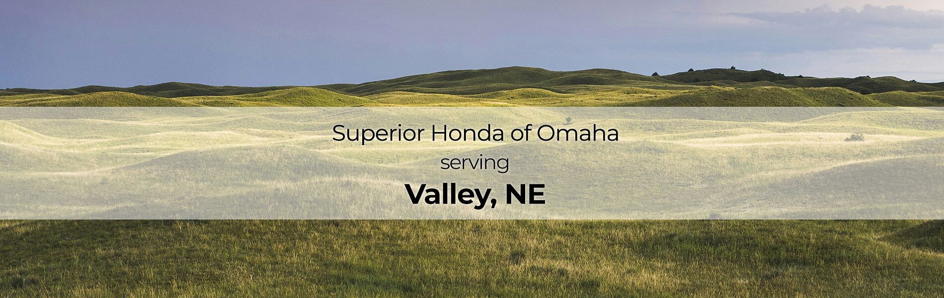 Green hills in background with text on front Superior Honda of Omaha serving Valley, NE
