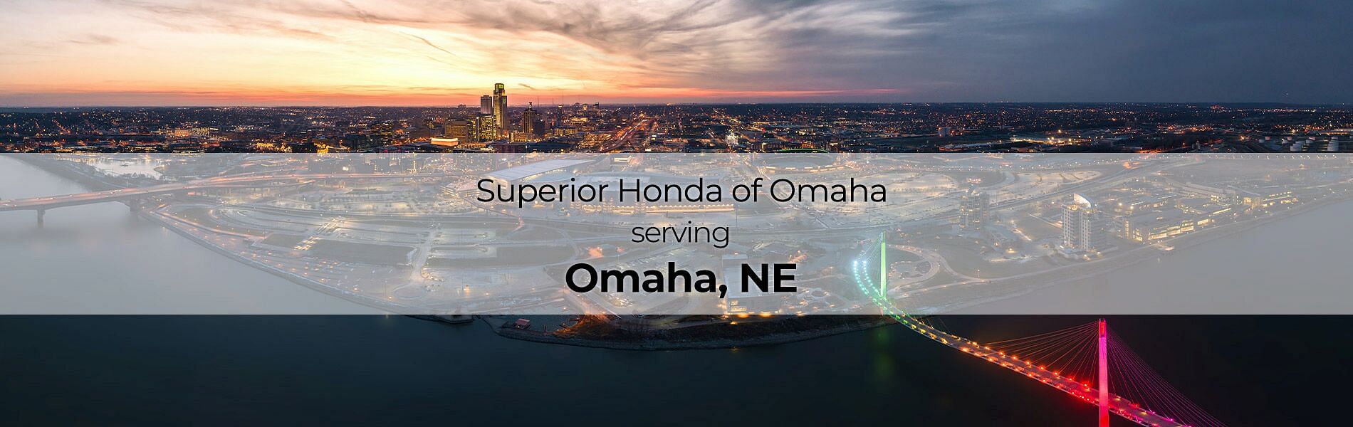 City in the background with text on the front: Superior Honda of Omaha serving Omaha, NE