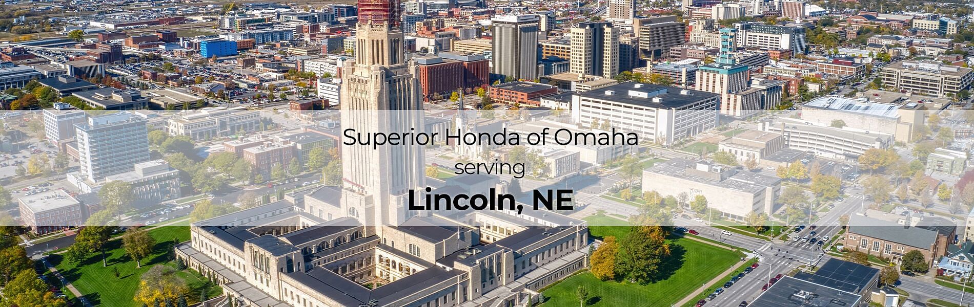 City in the background with text Superior Honda of Omaha serving Lincoln, NE