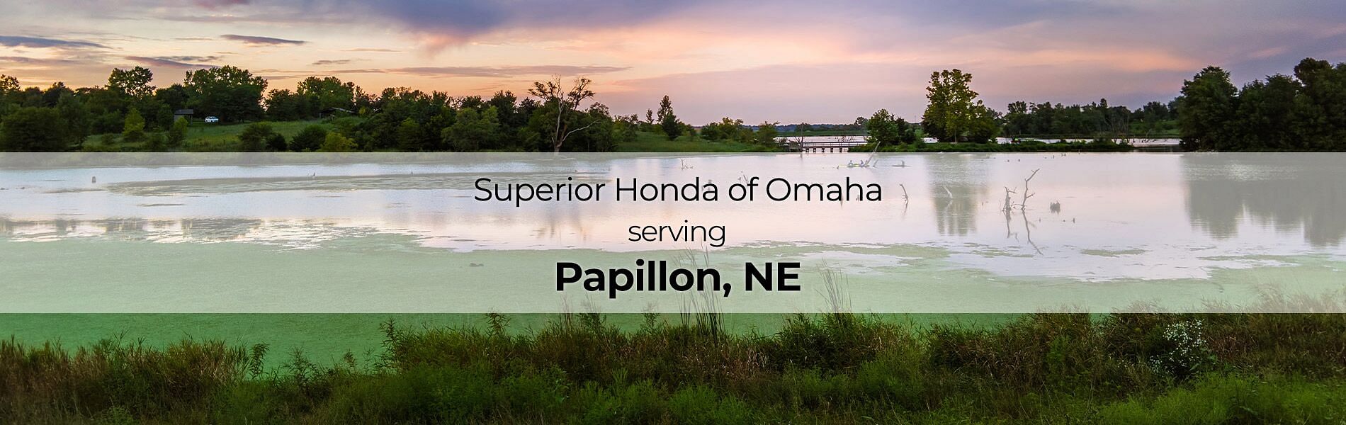 Lake in the background with text on front: Superior Honda of Omaha Serving Papillon, NE