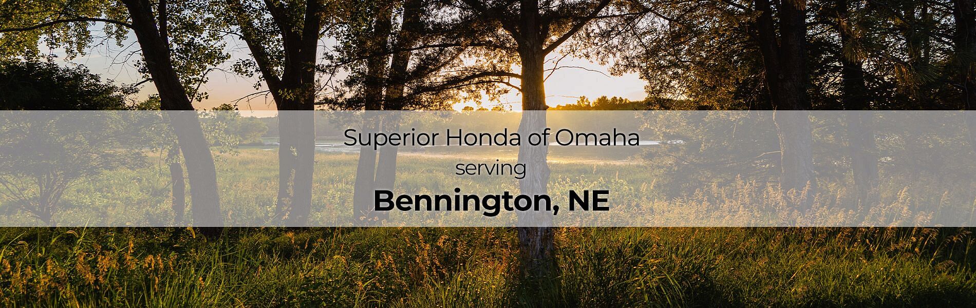 Forest in the background with text in the front Superior Honda of Omaha serving Bennington, NE