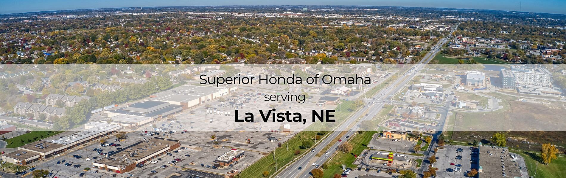 City in the background, text in the front Superior Honda of Omaha serving La Vista, NE