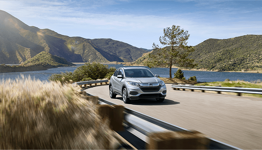 Honda car driving along the river