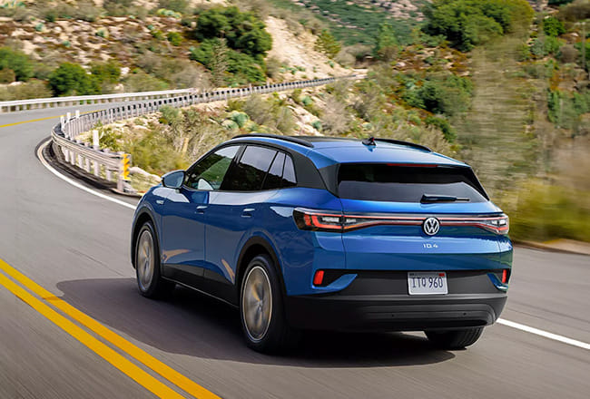 Blue Volkswagen SUV driving on a winding road