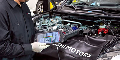 Mechanic checking oil