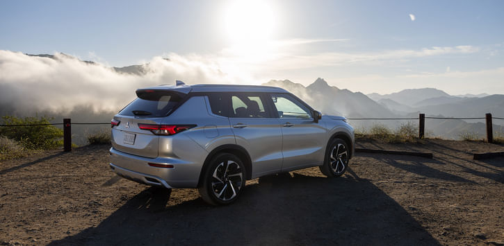 A SUV parked on a scenic mountain landscape, showcasing its sleek design against nature's backdrop.