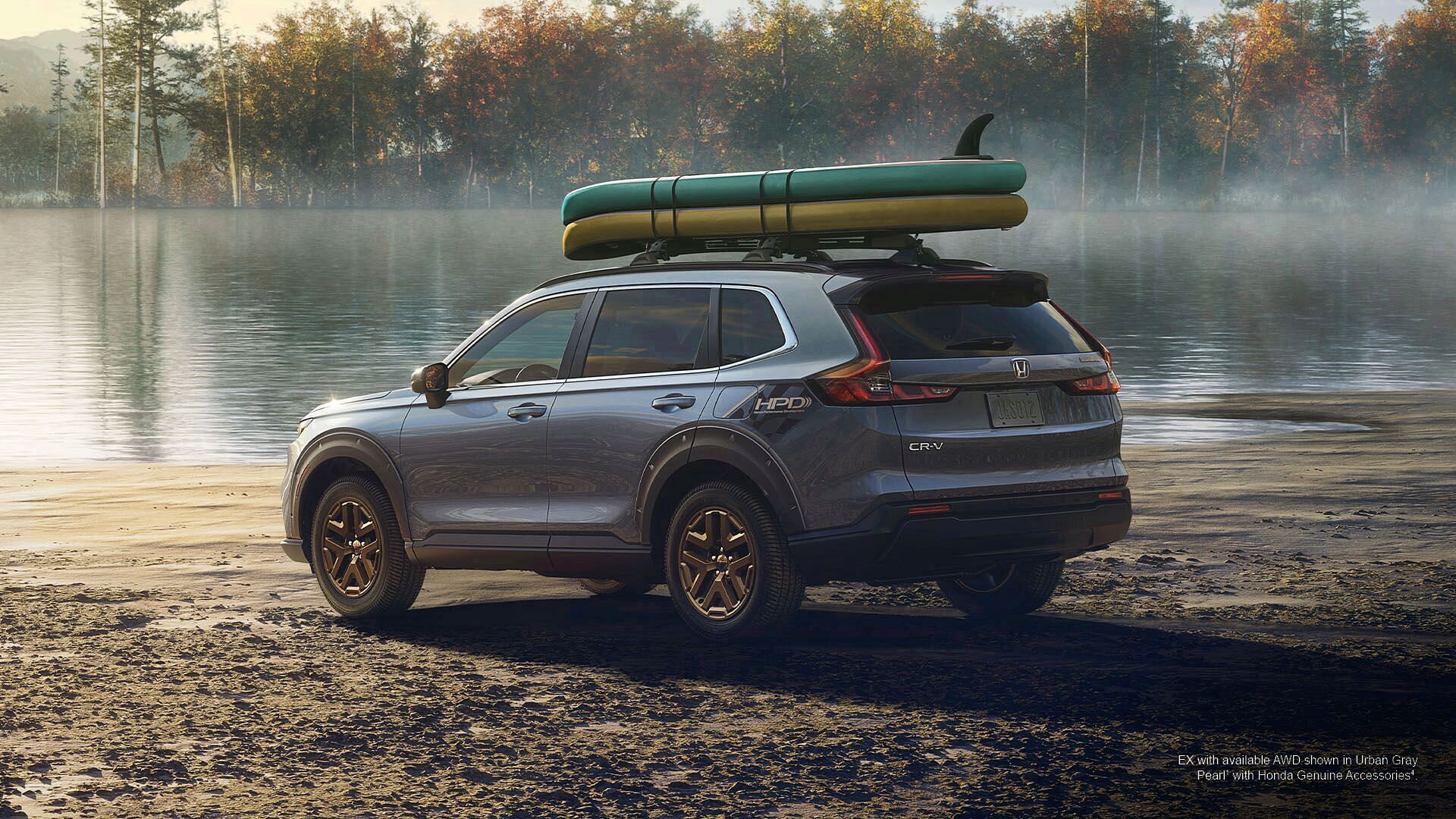 Honda 2023 CR-V Hybrid EX with available AWD shown in Urban Gray Pearl with Honda Genuine Accessories standing on lake shore.