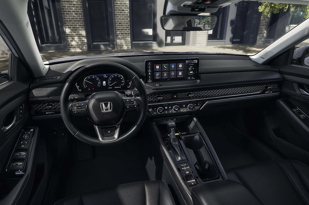 Interior del Honda Accord Hybrid 2026 presentando un tablero elegante, una pantalla digital y un volante multifunción. El diseño es minimalista y sofisticado.
