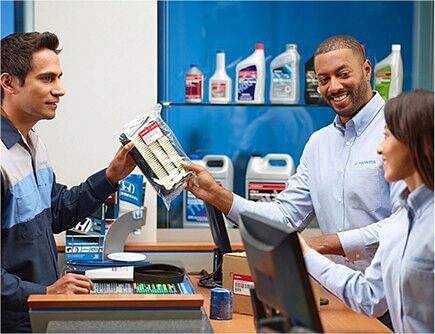 salesman gives the customer an air filter for the car