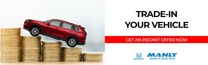 A red SUV is positioned on stacks of coins next to the text "Trade-In Your Vehicle. Get an Instant Offer Now." The Manly Honda and Santa Rosa logos are shown at the bottom right.