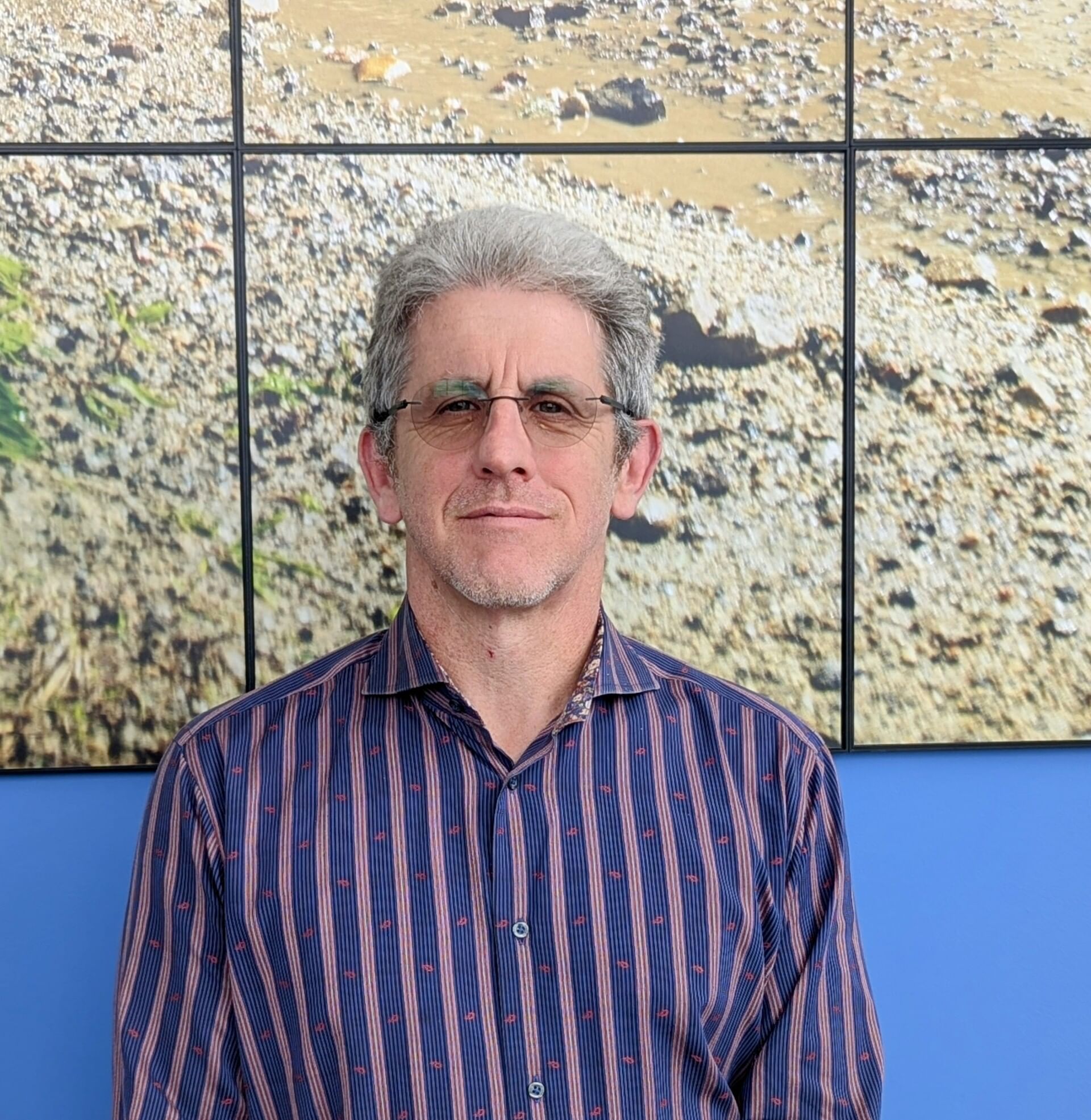 A man wearing striped shirt