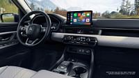 Interior of 2023 Honda Pilot Elite shown with Gray Leather. Wireless Apple CarPlay compatibility standard on EX-L and above.