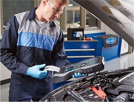 service technician checks the voltage status of the battery