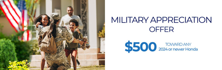 Woman in military uniform with a backpack returning home and embracing two joyful children, with an American flag in the background. Text on the right reads: 'Military Appreciation Offer – $500 toward any 2024 or newer Honda.'