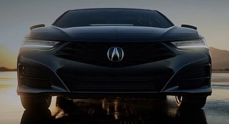 Front view of a TLX with sunset sky.