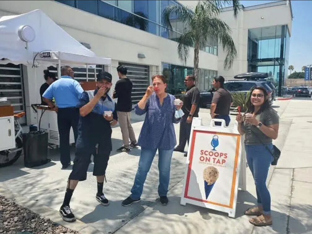 People taking a photo with an advertisement for an ice cream bar