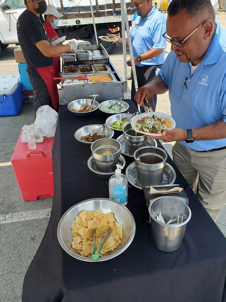 Workers prepare tacos