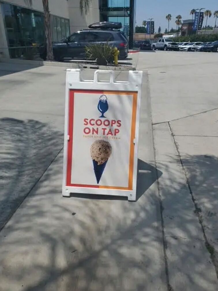 Ice cream advertisement on a board placed on the street